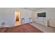 Bedroom showcasing a television and dresser, plus a view into the ensuite bathroom at 1504 Colt Creek Pl, Wesley Chapel, FL 33543