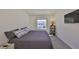 Bedroom showcasing a window with blinds, and a large television hanging on the wall at 1504 Colt Creek Pl, Wesley Chapel, FL 33543