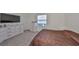 Bedroom with carpet, a window with blinds, and a white dresser with a large TV at 1504 Colt Creek Pl, Wesley Chapel, FL 33543