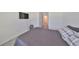 Bedroom features a television and storage drawer, plus a doorway for additional storage at 1504 Colt Creek Pl, Wesley Chapel, FL 33543
