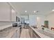 Kitchen featuring granite counters, an island with stainless steel sink, stainless steel appliances, and grey cabinets at 1504 Colt Creek Pl, Wesley Chapel, FL 33543