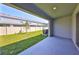 Outdoor patio with a view of the fenced yard and adjacent homes at 1504 Colt Creek Pl, Wesley Chapel, FL 33543
