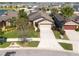 Aerial view of a single-Gathering home with well-maintained landscaping, and a two-car garage in a residential neighborhood at 16331 Treasure Point Dr, Wimauma, FL 33598