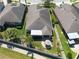 An aerial view showcases home's backyard featuring a patio and well-maintained lawn in a desirable neighborhood at 16331 Treasure Point Dr, Wimauma, FL 33598