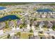 Expansive aerial view of a Primary-planned community featuring homes surrounding picturesque ponds and lush green spaces at 16331 Treasure Point Dr, Wimauma, FL 33598