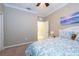 Bedroom featuring a light colored bedspread, a ceiling fan, and neutral walls at 16331 Treasure Point Dr, Wimauma, FL 33598