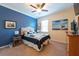 Comfortable bedroom features a ceiling fan and a plush, blue and white bedspread at 16331 Treasure Point Dr, Wimauma, FL 33598