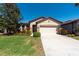 Charming single-Gathering home with a well-manicured lawn, beautiful landscaping, and a two-car garage at 16331 Treasure Point Dr, Wimauma, FL 33598
