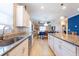 Spacious kitchen featuring granite counters, white cabinets and stainless steel appliances at 16331 Treasure Point Dr, Wimauma, FL 33598