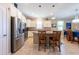 Bright kitchen featuring stainless steel appliances and granite countertops and a tile backsplash at 16331 Treasure Point Dr, Wimauma, FL 33598
