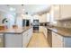 Bright kitchen with granite countertops, stainless steel appliances, and white cabinetry at 16331 Treasure Point Dr, Wimauma, FL 33598