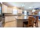 Well-equipped kitchen featuring granite countertops, a mosaic backsplash, and an island at 16331 Treasure Point Dr, Wimauma, FL 33598