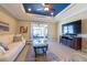 Bright living space with ample seating and entertainment center at 16331 Treasure Point Dr, Wimauma, FL 33598