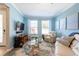 Stylish living room featuring a large window, light-blue walls, and comfortable seating at 16331 Treasure Point Dr, Wimauma, FL 33598