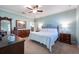 Tranquil primary bedroom featuring light-blue walls, a ceiling fan, and generous natural light at 16331 Treasure Point Dr, Wimauma, FL 33598