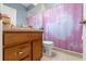 Traditional bathroom with a single sink vanity and pink shower curtain at 16340 Marquis Rd, Brooksville, FL 34614