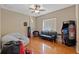 A flexible bedroom space with a futon, arcade machine, and hardwood flooring at 16340 Marquis Rd, Brooksville, FL 34614