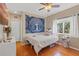 Inviting bedroom with decorative tapestry and bright window at 16340 Marquis Rd, Brooksville, FL 34614