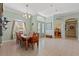 Dining room features a modern chandelier, large windows, and stylish decor at 16340 Marquis Rd, Brooksville, FL 34614