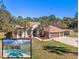 Inviting exterior of home with a pool, three-car garage, well-kept lawn, and palm tree accents at 16340 Marquis Rd, Brooksville, FL 34614