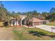 Charming single-story home with well-manicured lawn and palm trees at 16340 Marquis Rd, Brooksville, FL 34614