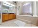 Elegant bathroom with tile floors, a soaking tub, and a large vanity area at 16340 Marquis Rd, Brooksville, FL 34614