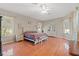 Spacious main bedroom with hardwood floors, a comfortable bed, dressers and large windows with valances at 16340 Marquis Rd, Brooksville, FL 34614