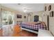 Spacious main bedroom with wood floors, a ceiling fan, and sliding glass door to the lanai at 16340 Marquis Rd, Brooksville, FL 34614