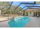 Backyard pool featuring a spa, beautiful landscaping, and a screened-in enclosure for year-round enjoyment at 16340 Marquis Rd, Brooksville, FL 34614