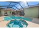 Backyard pool featuring a spa and screened-in enclosure, and seamless transition between indoor and outdoor living at 16340 Marquis Rd, Brooksville, FL 34614