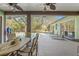 Screened in patio featuring dining area and lounge chairs adjacent to a refreshing swimming pool and beautiful backyard at 16340 Marquis Rd, Brooksville, FL 34614