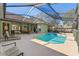Relaxing backyard features a sparkling pool, lounge chairs, and a screened-in enclosure, perfect for outdoor enjoyment at 16340 Marquis Rd, Brooksville, FL 34614