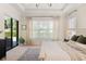 A light and airy main bedroom featuring a decorative rug and access to the back yard at 16532 Ballyshannon Dr, Tampa, FL 33624