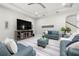 Open living room featuring modern furniture, a ceiling fan, and a view of the staircase at 17915 Barn Close Dr, Lutz, FL 33559