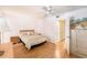 Comfortable bedroom with wood floor and ceiling fan features hall access at 1900 59Th N Ave # 217, St Petersburg, FL 33714