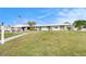 Welcoming clubhouse with an American flag, lush lawn, and convenient parking at 1900 59Th N Ave # 217, St Petersburg, FL 33714