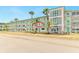 Multi-story condominium building with tropical landscaping, turquoise accents, and well-maintained grounds at 1900 59Th N Ave # 217, St Petersburg, FL 33714
