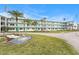 Low angle shot of updated condo building with turquoise railings and doors with meticulous landscaping at 1900 59Th N Ave # 217, St Petersburg, FL 33714