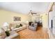 Cozy living room with hardwood floors, ceiling fan and comfortable seating area next to dining table at 1900 59Th N Ave # 217, St Petersburg, FL 33714