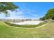 Scenic view of a pond surrounded by lush greenery and condos under a bright blue sky at 1900 59Th N Ave # 217, St Petersburg, FL 33714