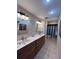 Bathroom with double sinks, granite counters, and a neutral color palette at 2114 Indian N Ave, Belleair Bluffs, FL 33770