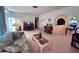 Inviting living room featuring a floral couch, piano, and charming decor at 2114 Indian N Ave, Belleair Bluffs, FL 33770