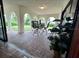 Inviting covered patio with brick flooring, comfortable seating, and a relaxing outdoor ambiance at 2114 Indian N Ave, Belleair Bluffs, FL 33770