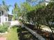 Beautiful backyard with lush greenery, trees and a stone retaining wall at 21537 Clubside Loop, Lutz, FL 33549