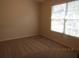 Cozy bedroom featuring neutral paint, carpet, and a sunny window at 21537 Clubside Loop, Lutz, FL 33549
