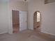 Neutral bedroom with archway to bathroom and large doorway to a carpeted room at 21537 Clubside Loop, Lutz, FL 33549