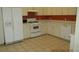Functional kitchen with white cabinets, appliances, and tile flooring at 21537 Clubside Loop, Lutz, FL 33549