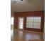 Spacious living room with wood floors, a door to a porch and a large window at 21537 Clubside Loop, Lutz, FL 33549