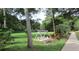 Tranquil swing set nestled among trees and manicured landscaping at 21537 Clubside Loop, Lutz, FL 33549