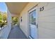 Building featuring a private balcony with door number twenty-three, white railings, and neutral siding at 2259 Costa Rican Dr # 23, Clearwater, FL 33763